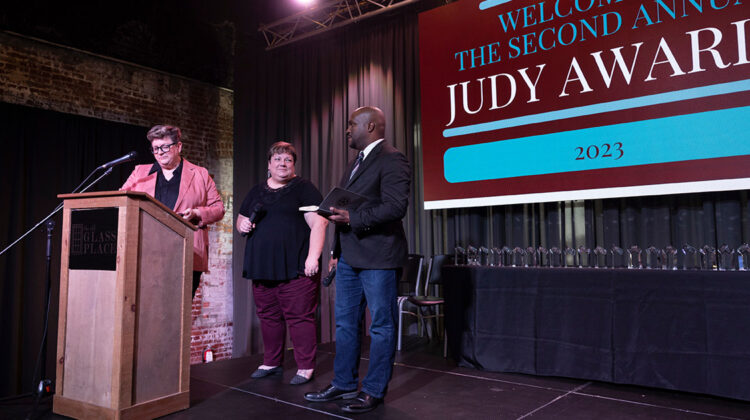2023 Judy Awards hosts Larson, Golden and Horton on stage at The Old Glass Place