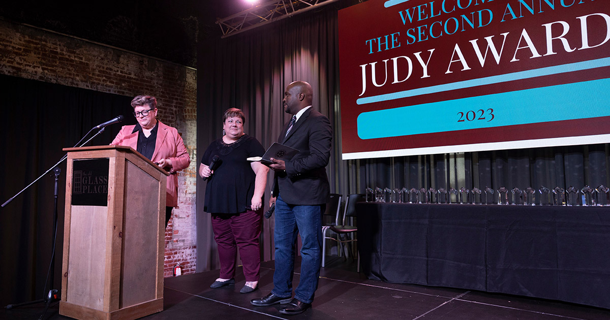 2023 Judy Awards hosts Larson, Golden and Horton on stage at The Old Glass Place