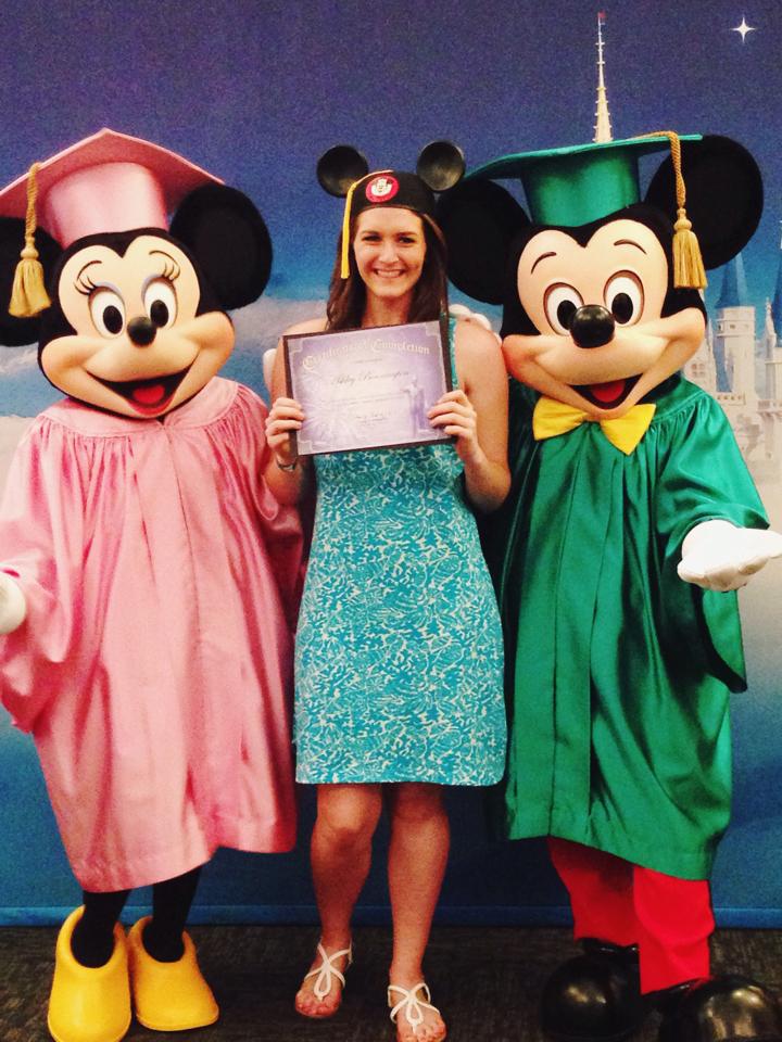 Ashley in graduation cap with Mickey and Minnie Mouse also in graducation caps