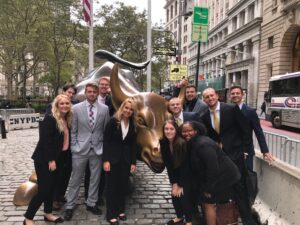 Students with the bull statue on Wall Street in New York.