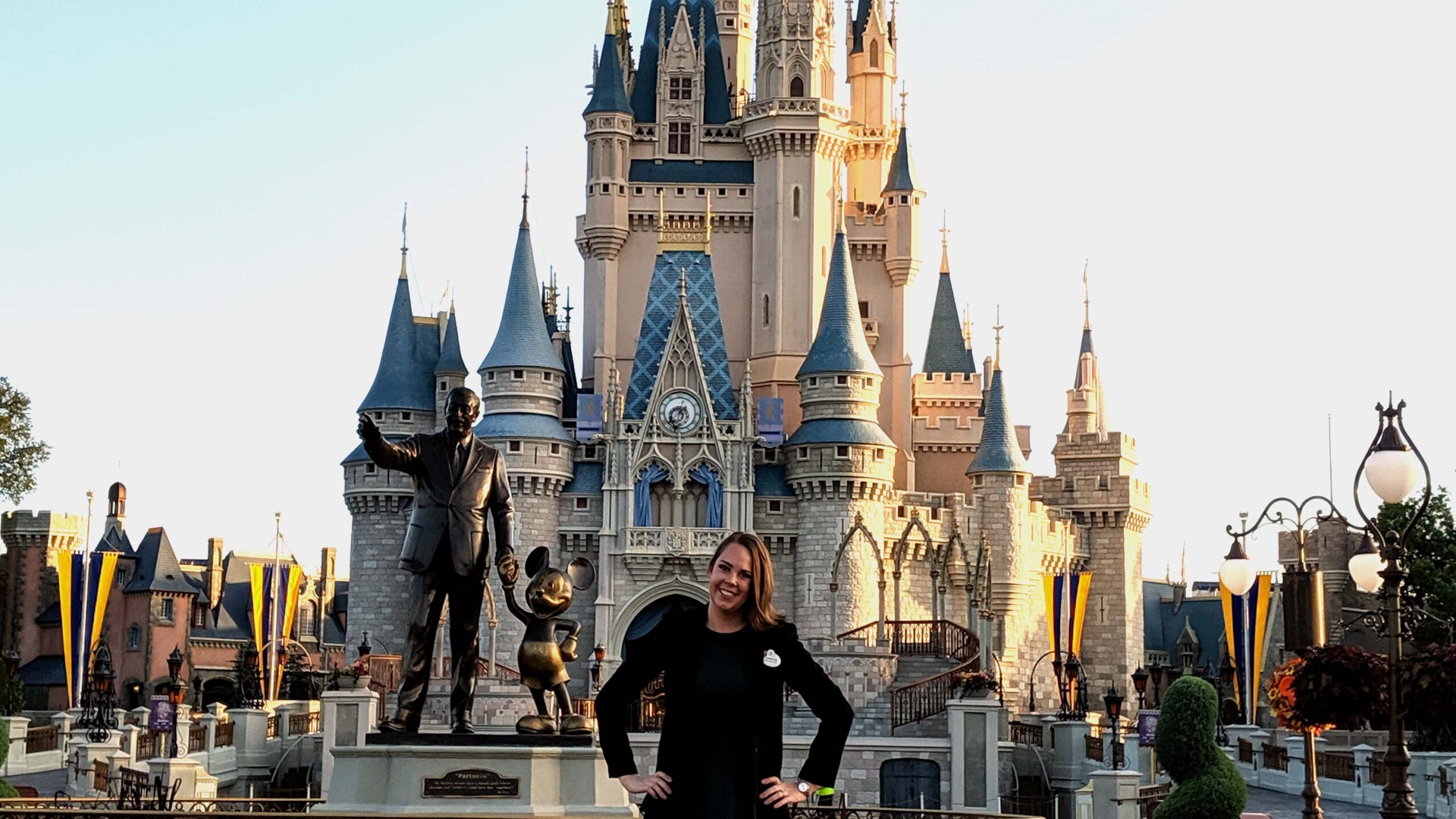 Woman standing in front of castle at DisneyWorld.