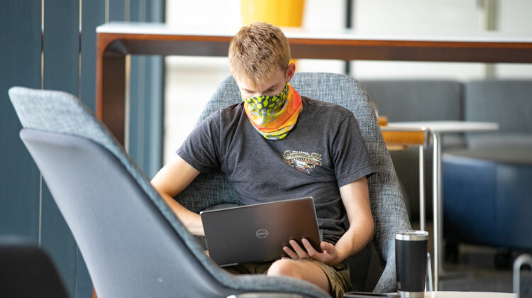 Student wears mask in Glass Hall.