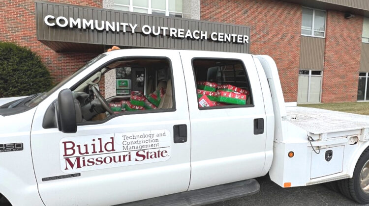 The official TCM truck loaded with presents and parked in front of the Community Outreach Center.