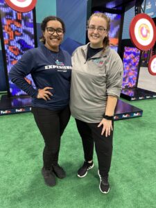 Emily Eigenmann and EMA student Tahniya Redus at their station for the Super Bowl Experience event.