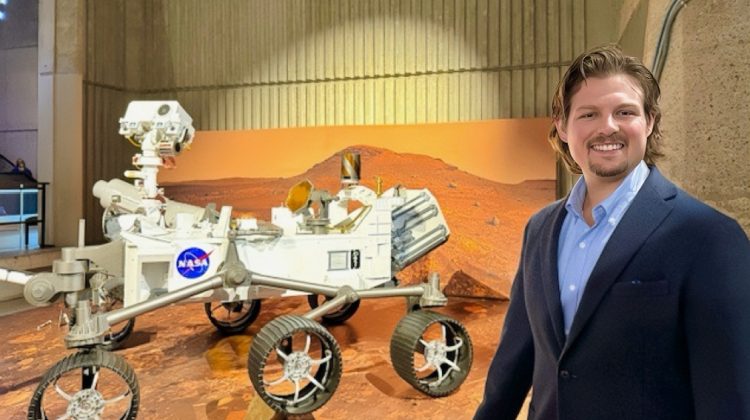 Brandon Lentz with a NASA Mars rover model.