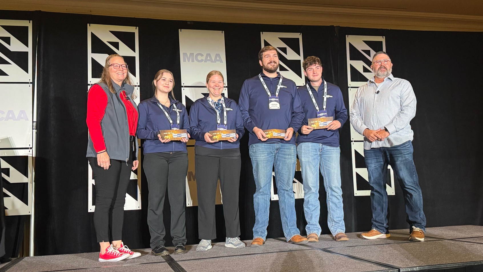 The Missouri State University winning team: Mya Duke (second from left), Jessica Greenland (third from left), Stephen Haight (fourth from left) and Will Blaine (fifth from left) with two MCAA representatives.