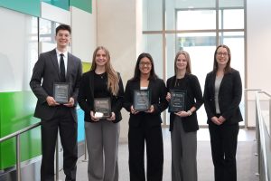 Dr. Megan Ramsey (right) with students in the CFA Institute Research Challenge.