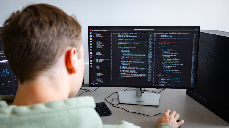 A Missouri State University student working on a computer.