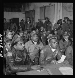 Photos of several Tuskegee Airmen attending a briefing in Italy, March 1945