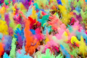 Holi celebration with bright colored powder being thrown in the air