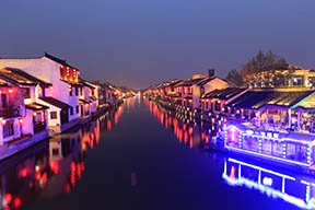 Houses and buildings on the waterfront lit up for Qingming festival