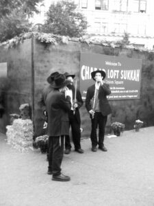 Jewish men at a sukkah for Sukkot