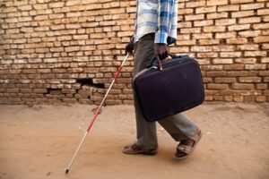 A blind student, walks with his cane at the Sudanese Association for Disabled People in El Fasher, North Darfur.