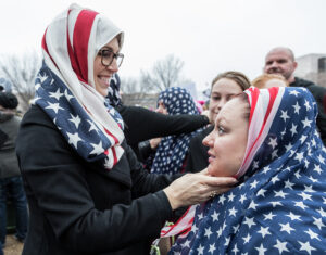 Two women wearing American flag scarves