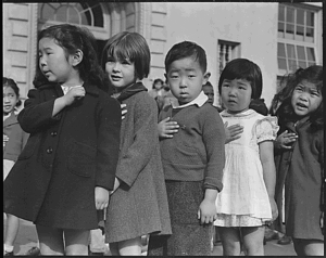 First-graders, some of Japanese ancestry, at the Weill public school pledging allegiance to the United States flag.