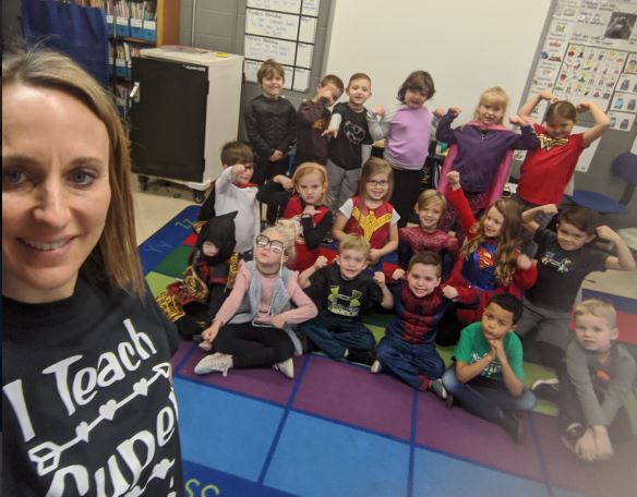 Michelle Slominsky poses with her students in her classroom.