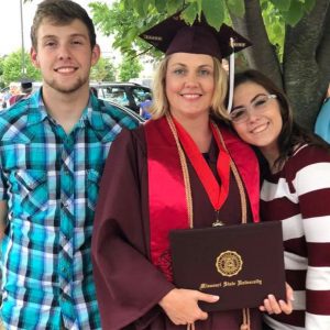 Annie with her children on her graduation day