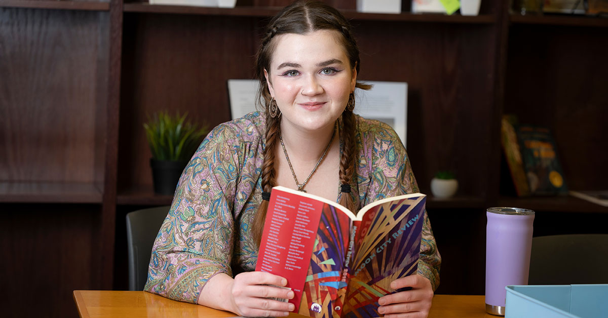 Alana Rowan reading a book in the Student Success Lounge in Siceluff Hall.
