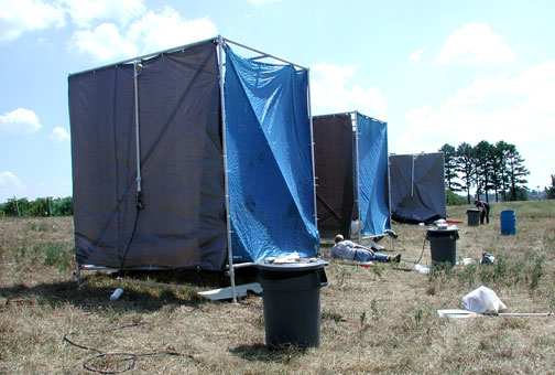 The researchers simulate rainfall under the tarps and collect the surface water runoff generated in the simulations.