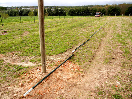 The T posts are laid down the row next to the wire stretched from end post to end post.