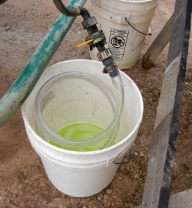 The spray from the 1 minute run is collected in a bucket for each of the 4 outlets.