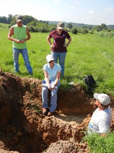 Tom DeWitt evaluates the soil pit and interprets it for us.