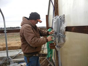 Randy covers the breaker box with plastic.