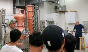 The students tour the distillery with C. J. Odneal.