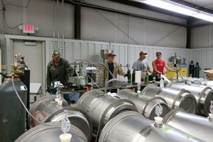 C. J. (left), Karl (Dr. Wilker), Tom and Avery are bottling Maroon Blend from 2017 to make room for the 2018 wine coming in.
