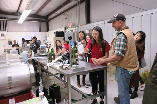 The last step in the bottling line is putting the capsule on the wine bottle.