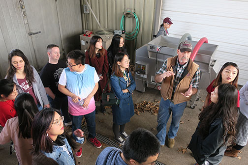 C. J. explains how the grapes are brought in from the field for winemaking.