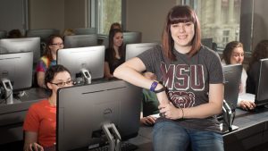 Dr. Buchanan in a computer lab with students.