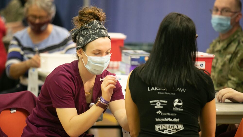 A student receives a vaccine dose.