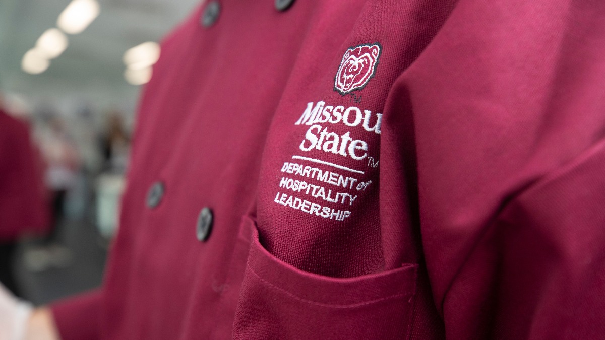 A student adorns a Missouri State University Department of Hospitality Leadership uniform while working in Carrie's Café.