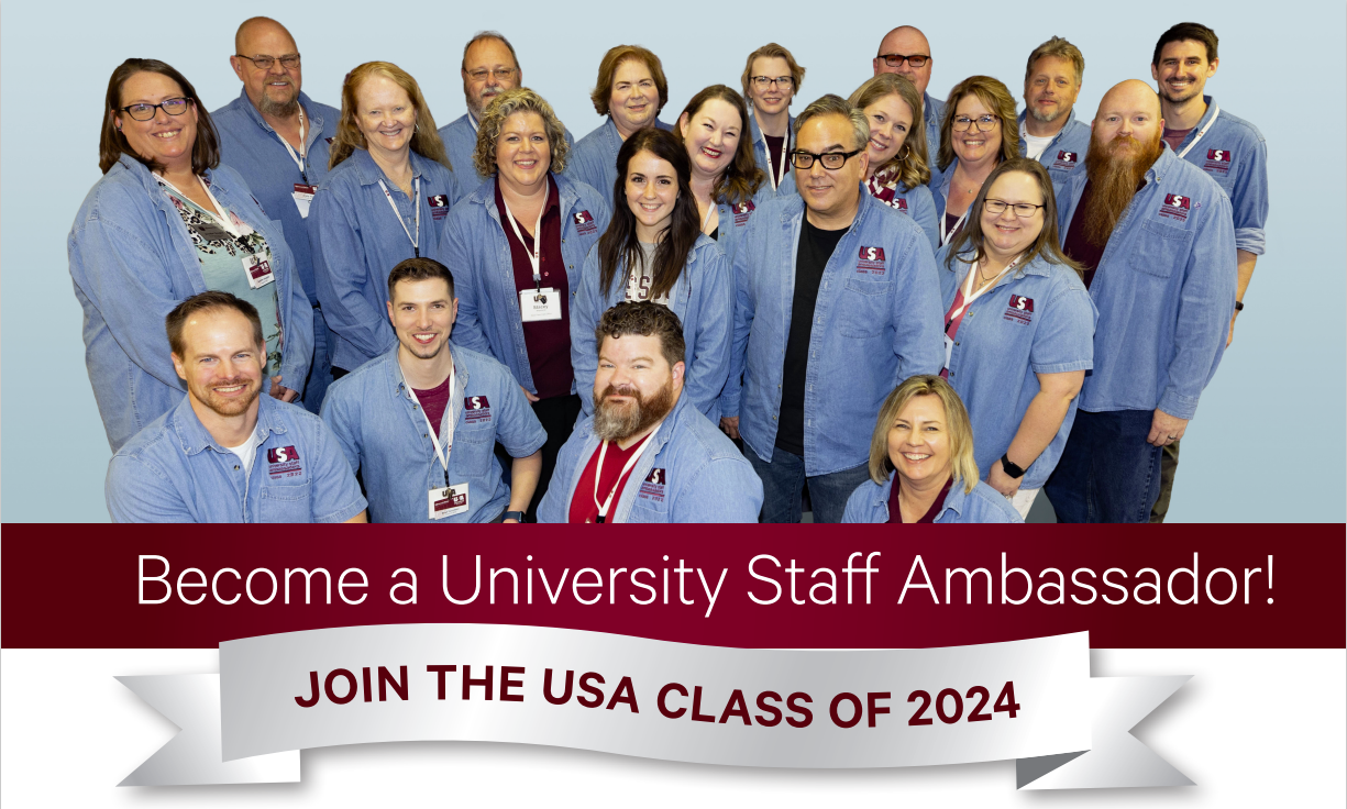 A group of people wearing denim shirts stand in front of a blue background. Become a University Staff Ambassador! Join the USA Class of 2024.