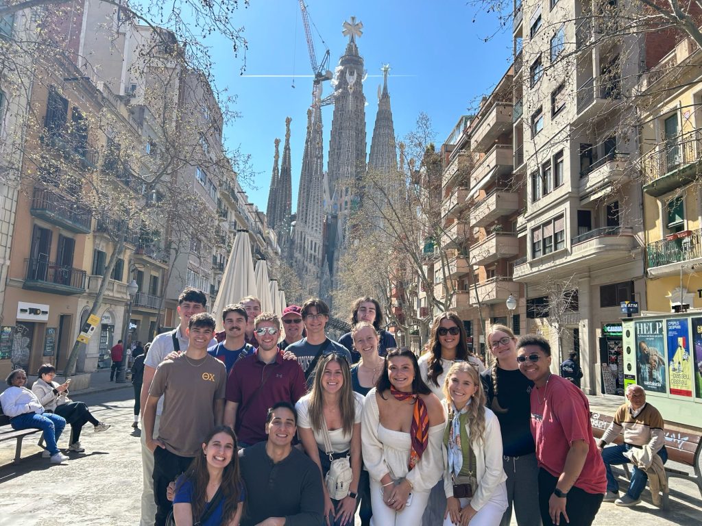 Students pose in front of La Sagrada Familia in Barcelona, Spain