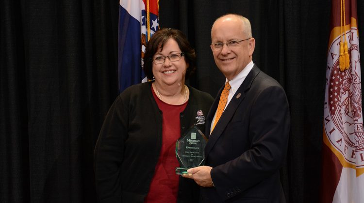 Kathy Davis receives award from President Smart