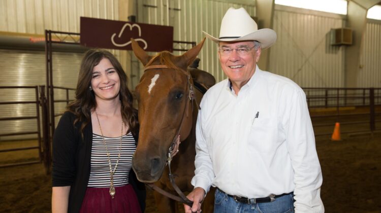 Sudbrock poses with Dr. Anson Elliott with horse in Pinegar Arena