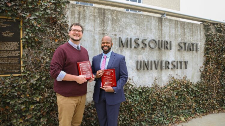 Dr. Kyler Sherman-Wilkins and David Johnson stand with their advising awards.