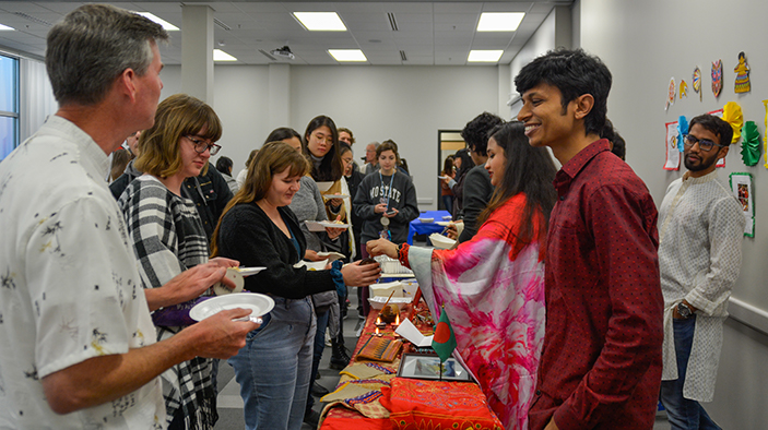 International students sharing foods with guests.