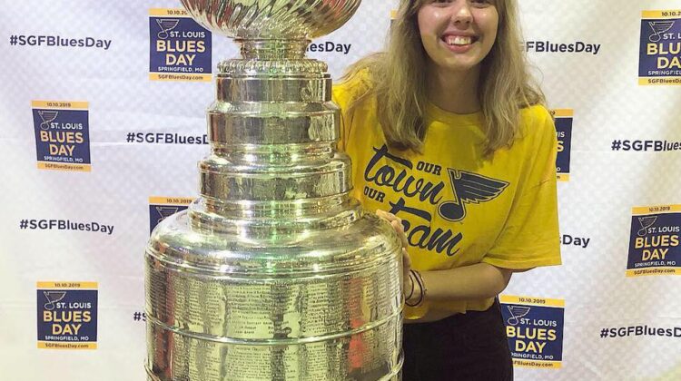LOGOS Copy Editor for Volume 13 Emma Bishop poses with the Stanley Cup wearing St. Louis Blues gear
