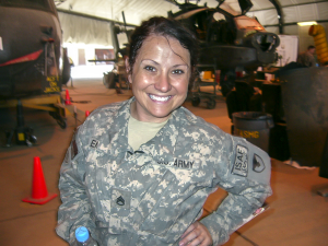Photo of Tracey Emily in uniform in font of a helicopter