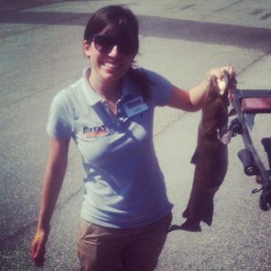 Carly holding a fish at a fishing tournament with Meek's. 