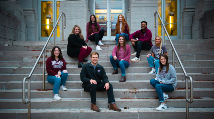 Members of the 2021 MSU Ad Team sit on the steps of Carrington Hall