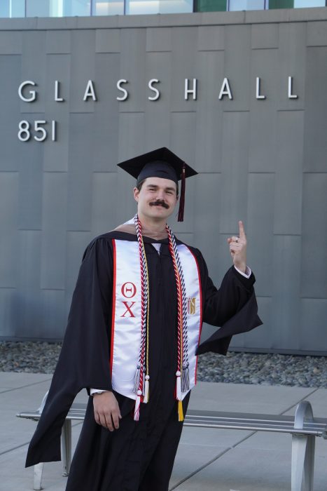 Ethan D. Scott smiling in a graduation portrait as he celebrates earning his MBA from Missouri State University and preparing to begin his career with Higginbotham.