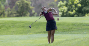 Helena Bel swings her golf club during a tournament.