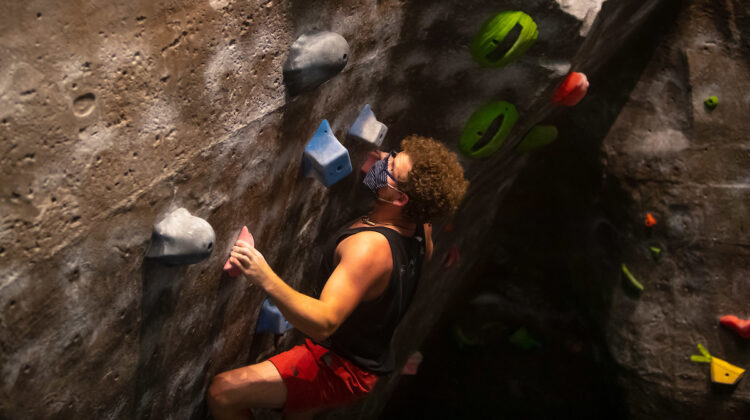 Person climbing rock wall