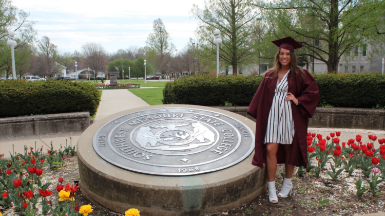 Sarah Rowland poses in her cap and gown on Missouri State campus