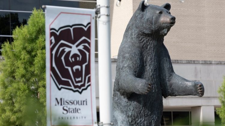Bear Statue with Missouri State University Flag.