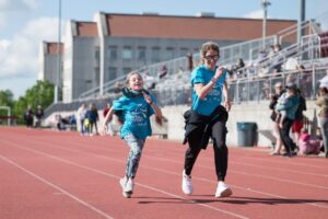 O’Neil in action with a kid at Girls on the Run.